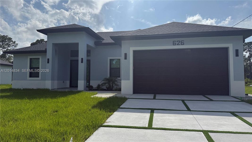 Front exterior of a new home in , Lehigh Acres, FL, highlighting curb appeal (Image 31).