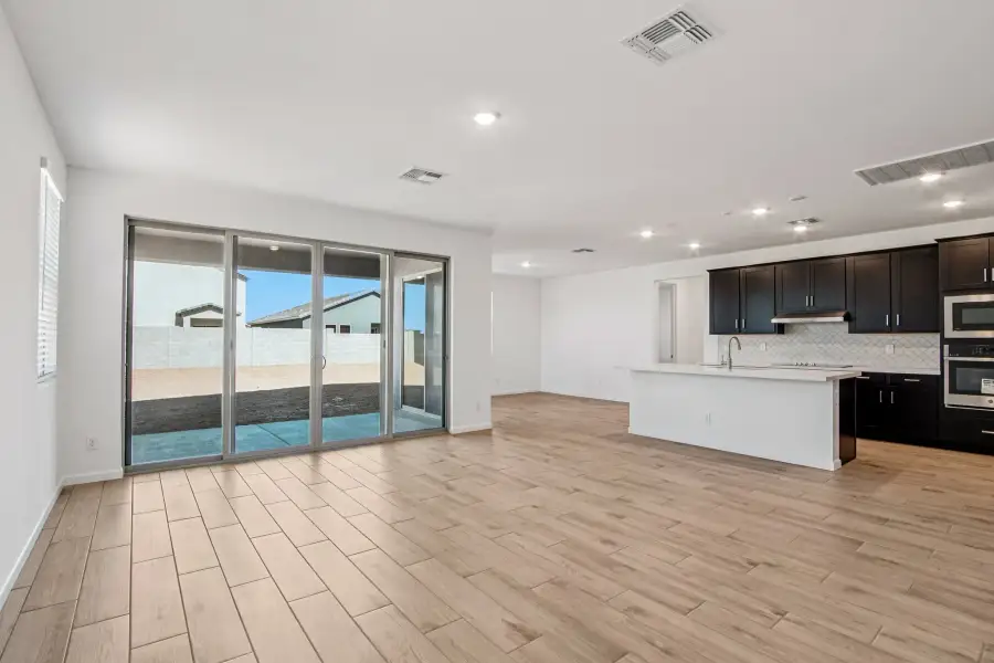 Great room, dining and kitchen. Finishes may vary by community.