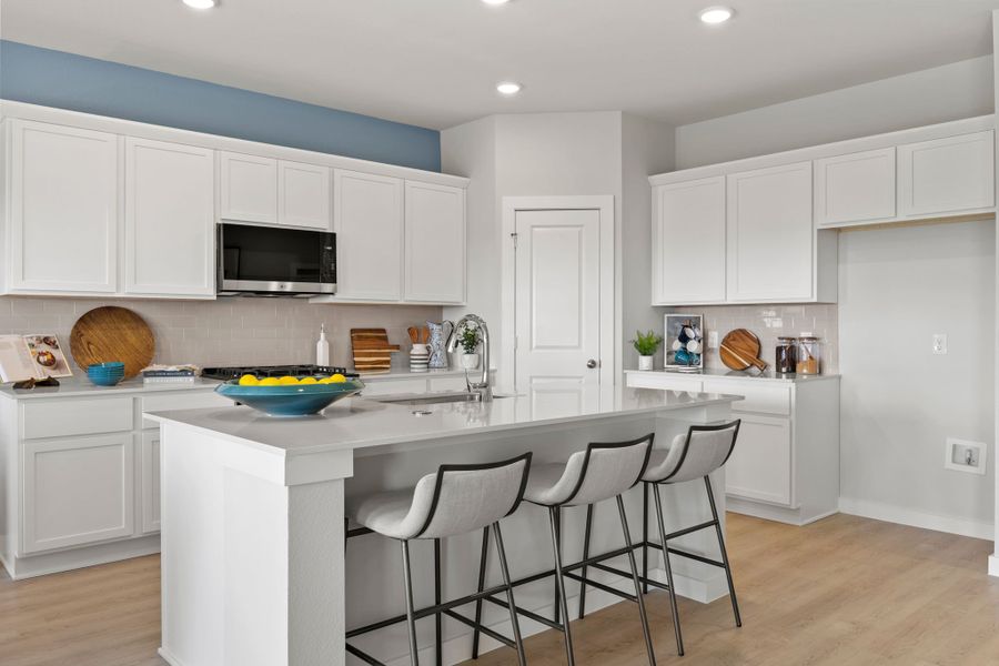 A kitchen with white cabinets. A kitchen with white cabinets.