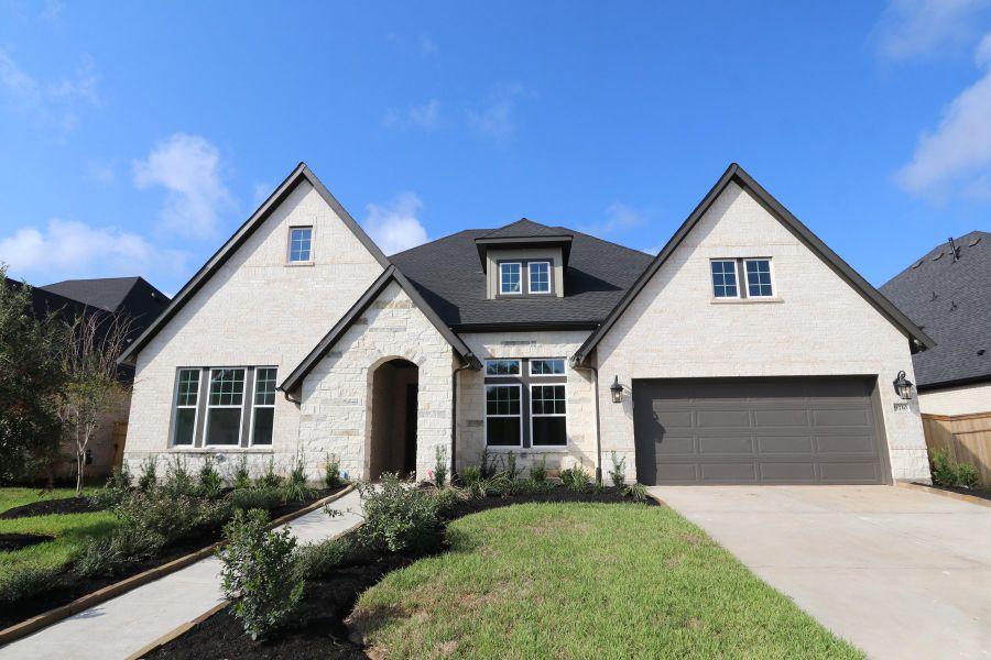 Front exterior of a new home in Sienna 65' Homesites, Missouri City, TX, highlighting curb appeal (Image 2).