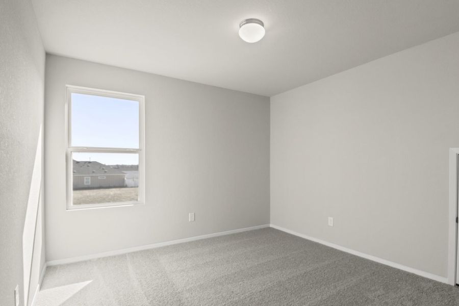 Image of a bedroom with cream walls, tan carpeting, a window and white trim Image of a bedroom with cream walls, tan carpeting, a window and white trim