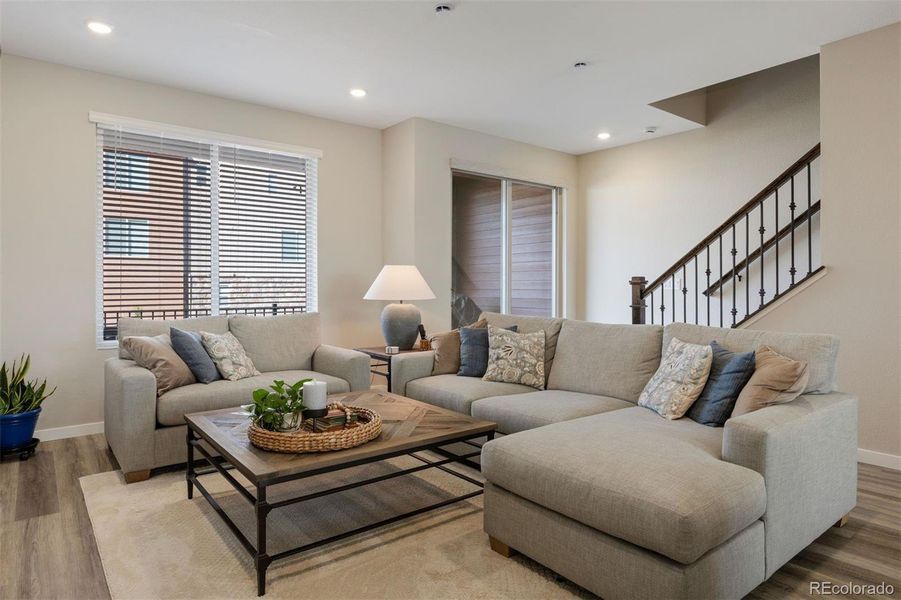 A warm, inviting living room offers generous seating and seamless flow, creating an ideal setting for relaxed gatherings.