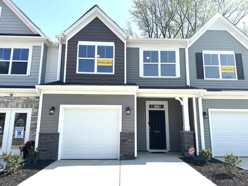 Front exterior of a new home in East Main Townes, Spartanburg, SC, highlighting curb appeal (Image 1). Front exterior of a new home in East Main Townes, Spartanburg, SC, highlighting curb appeal (Image 1).