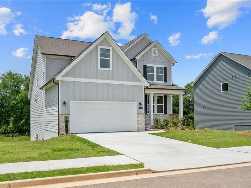 Front exterior of a new home in Wehunt Meadows, Hoschton, GA, highlighting curb appeal (Image 2). Front exterior of a new home in Wehunt Meadows, Hoschton, GA, highlighting curb appeal (Image 2).