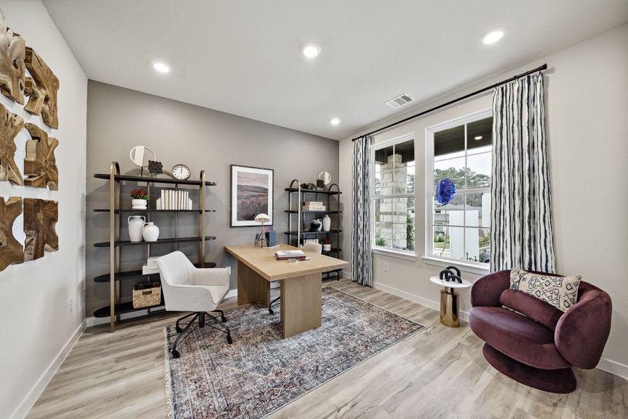 A living room with a table and chairs.