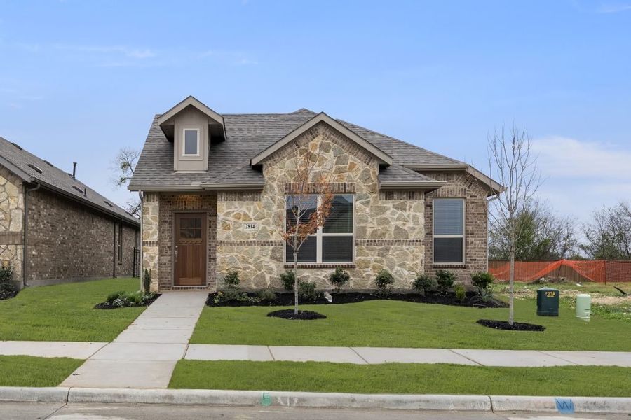 Front exterior of a new home in Redden Farms – Active Adult, Midlothian, TX, highlighting curb appeal (Image 1).