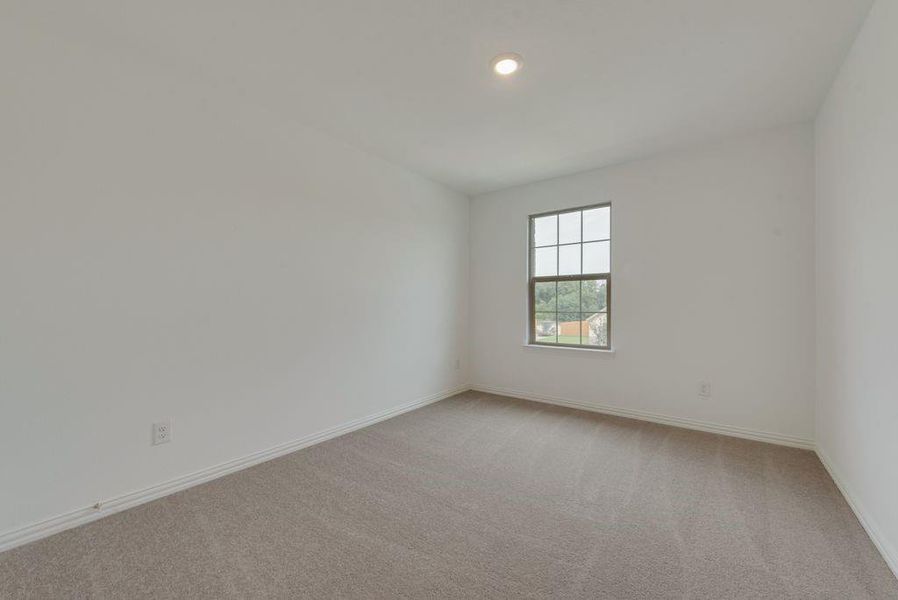 Empty room featuring light carpet and baseboards Empty room featuring light carpet and baseboards