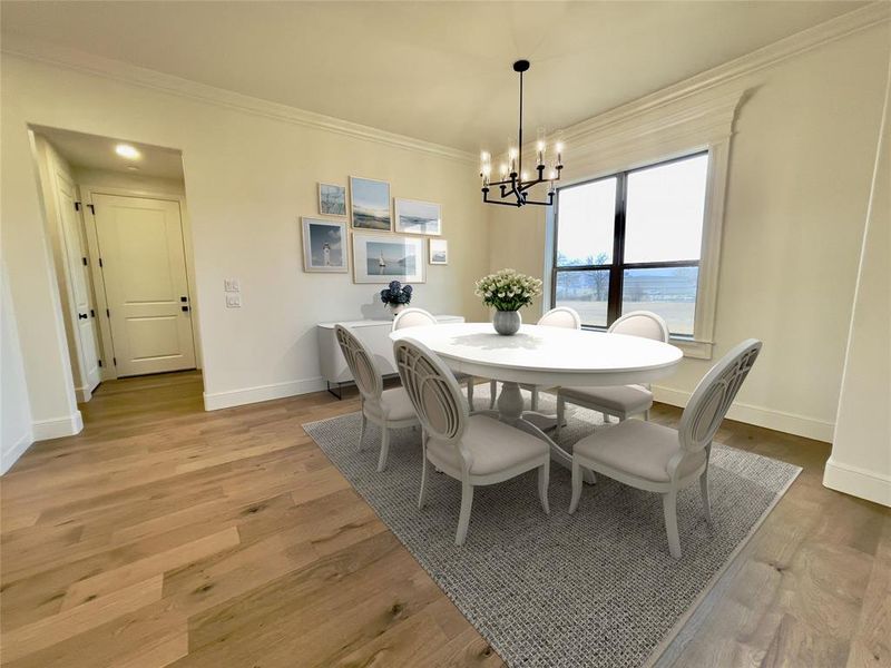 Dining room featuring an inviting chandelier & crown molding