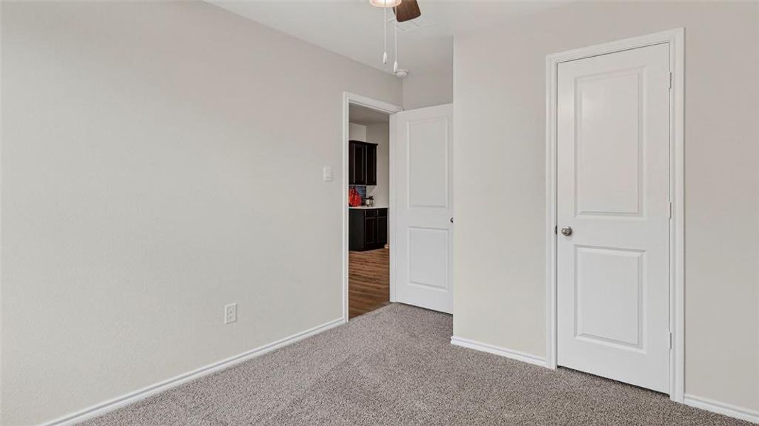 Neutral-toned walls and grey carpet flooring Neutral-toned walls and grey carpet flooring