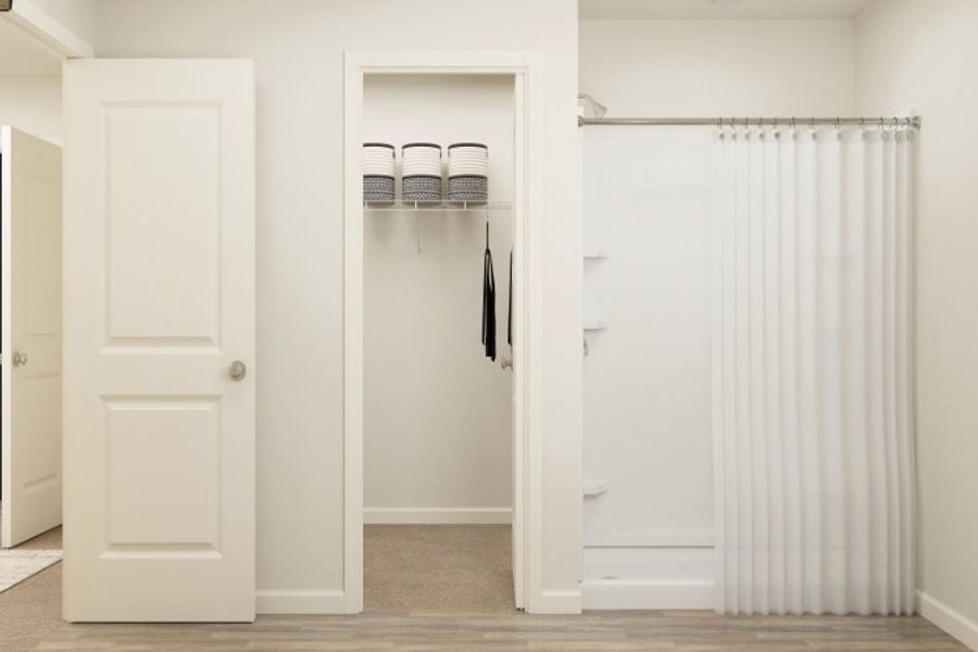 A closet with white doors. A closet with white doors.