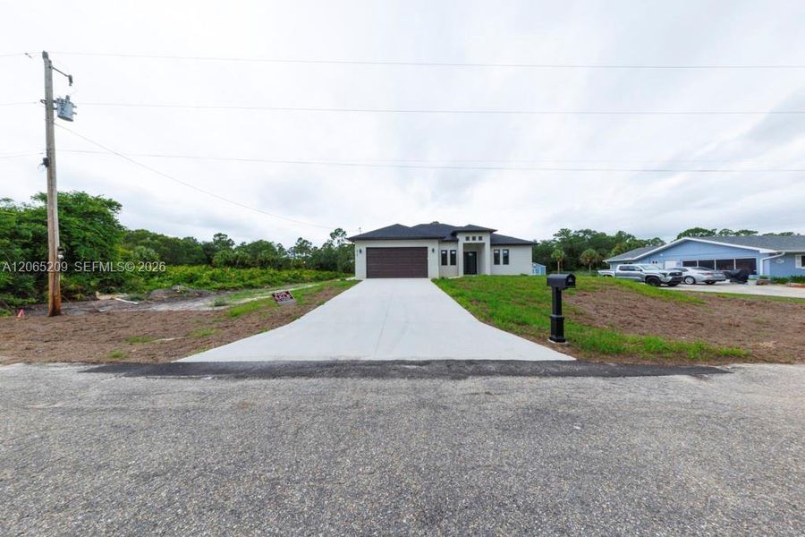 Front exterior of a new home in , Lehigh Acres, FL, highlighting curb appeal (Image 28).