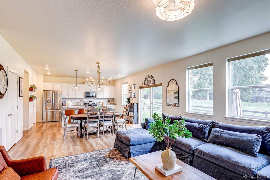 Open floor plan is highlighted by custom gold light fixtures Open floor plan is highlighted by custom gold light fixtures