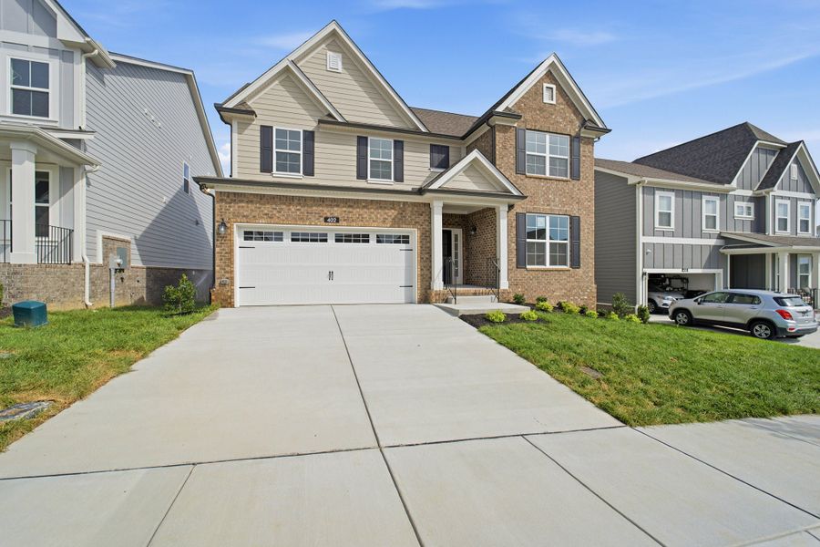Front exterior of a new home in McCain's Station, Gallatin, TN, highlighting curb appeal (Image 2). Front exterior of a new home in McCain's Station, Gallatin, TN, highlighting curb appeal (Image 2).