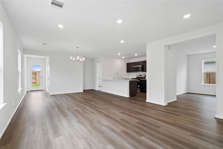 Stunning open-concept design seamlessly connecting the living, dining, and kitchen areas—perfect for both everyday living and entertaining!