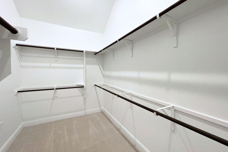 Ample hanging space and shelving create an organized wardrobe solution in this well-appointed closet.