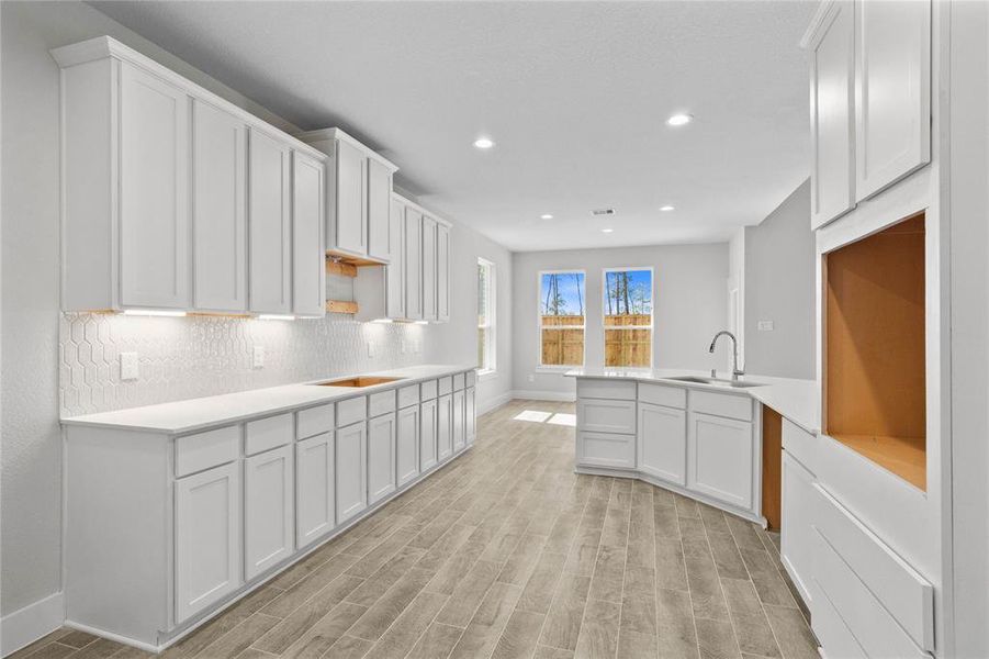 This kitchen is by far any chef’s dream! This spacious kitchen features high ceilings, stained wood cabinets, quartz countertops, SS appliances, modern tile backsplash, recessed lighting, extended counter space, extra space for breakfast bar, and a walk-in pantry all overlooking your huge family room.