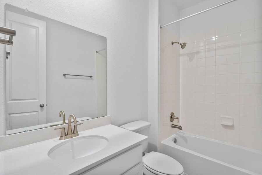A beautifully finished secondary bathroom showcasing timeless materials and clean lines.