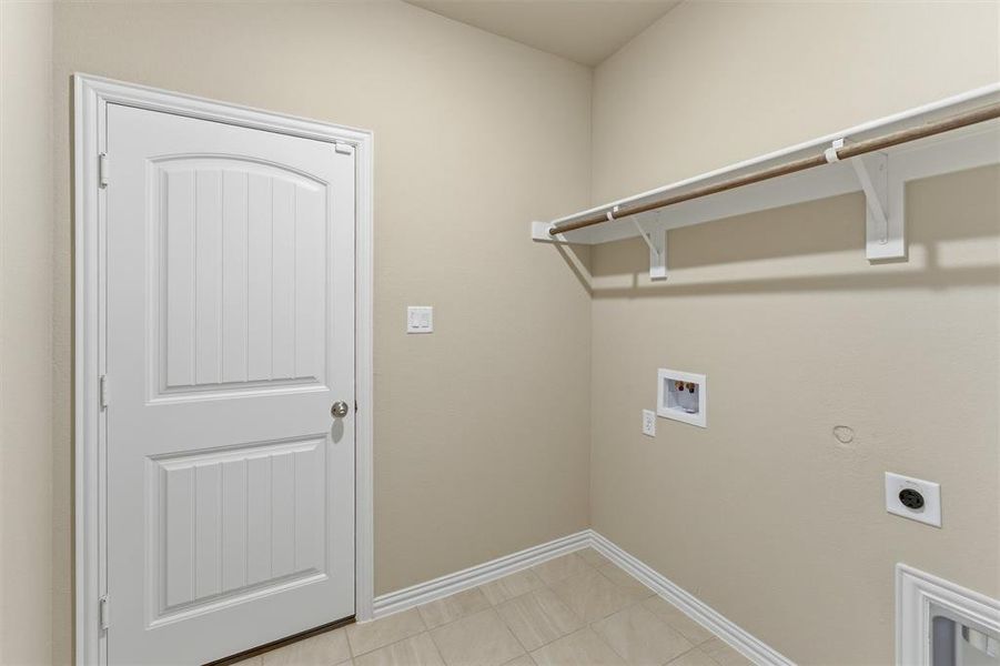 Laundry room featuring washer hookup, gas dryer hookup, electric dryer hookup, and light tile patterned floors