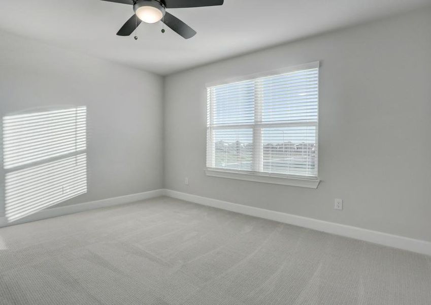 Secondary bedroom with large windows that allow natural light to flow through.