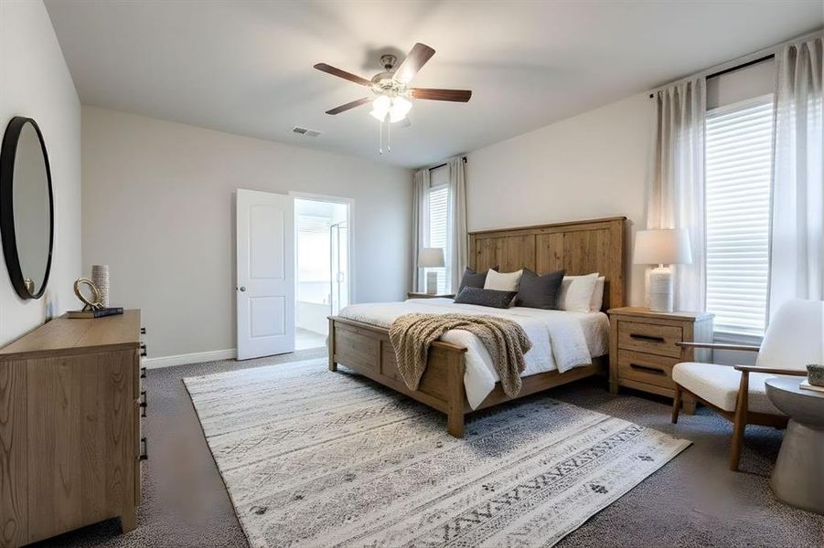 Carpeted bedroom with ceiling fan and ensuite bath Carpeted bedroom with ceiling fan and ensuite bath
