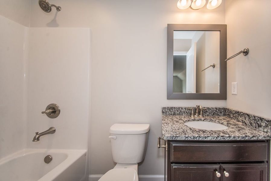 Representative furnished interior of a home built from the Quincy by Enchanted Homes in Hampshire Heights, Moore (Image 18).