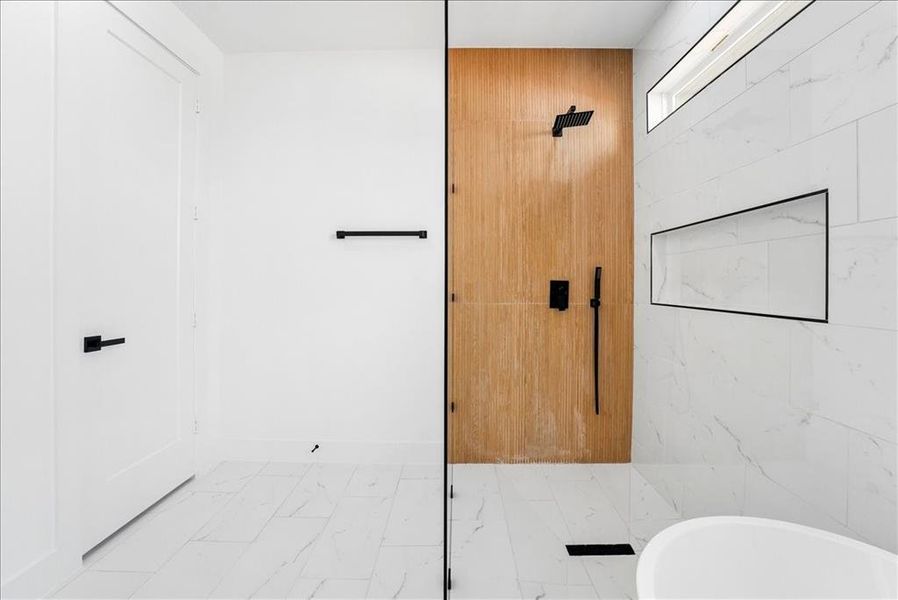 Modern shower enclosure featuring a wood-finish accent wall, matte black fixtures, and a recessed shower niche Modern shower enclosure featuring a wood-finish accent wall, matte black fixtures, and a recessed shower niche