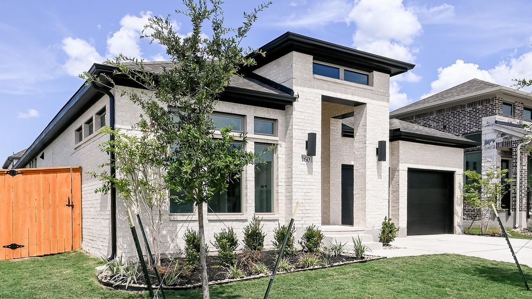 Contemporary home featuring an attached garage, brick siding, concrete driveway, and roof with shingles Contemporary home featuring an attached garage, brick siding, concrete driveway, and roof with shingles