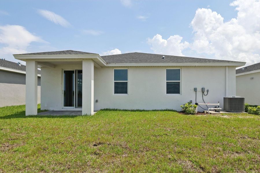 Front exterior of a new home in Hampton Park - Classic Series, Vero Beach, FL, highlighting curb appeal (Image 2). Front exterior of a new home in Hampton Park - Classic Series, Vero Beach, FL, highlighting curb appeal (Image 2).