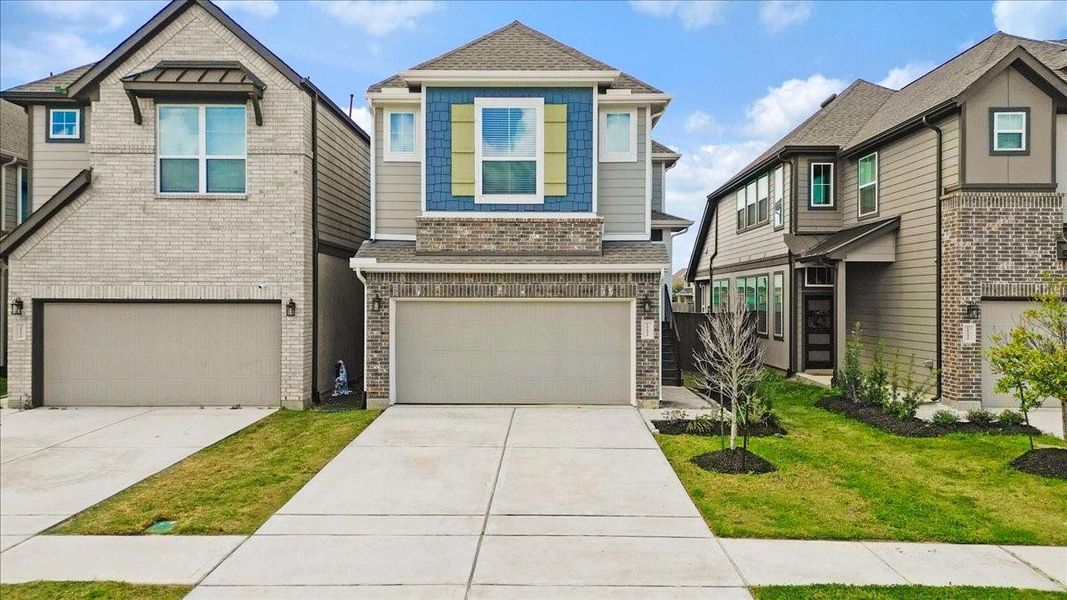 Front exterior of a new home in Meridiana, Iowa Colony, TX, highlighting curb appeal (Image 22).