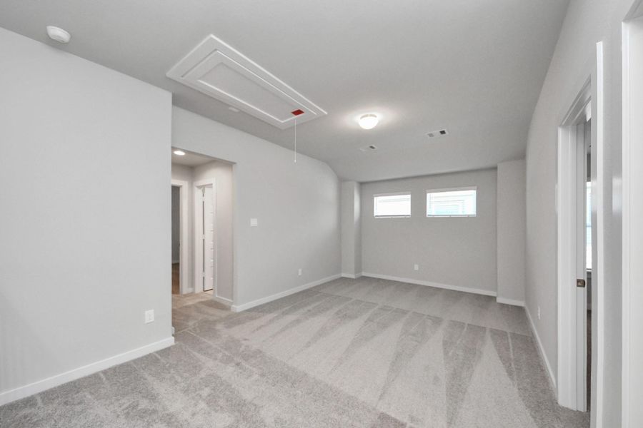 Ascend to relaxation in this fantastic game room! Ideal for both casual gatherings and adult gaming, it boasts plush carpet, lofty ceilings, custom paint, and ample windows for abundant natural light. Sample photo of completed home with similar floor plan. Actual colors and selections may vary.