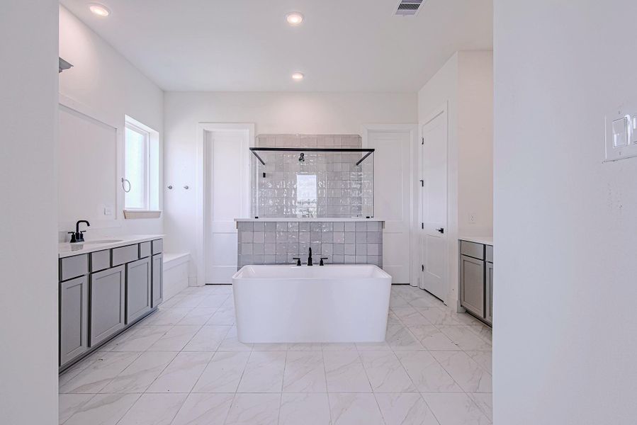 Spa-inspired ensuite with dual vanities and abundant counter space