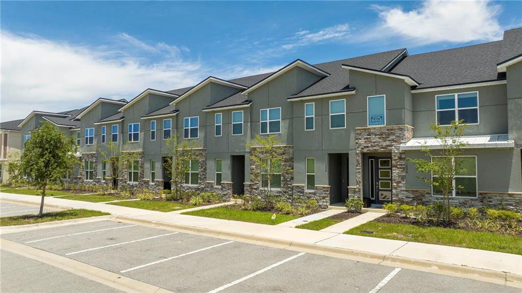 Front exterior of a new home in Solara Resort, Kissimmee, FL, highlighting curb appeal (Image 21).