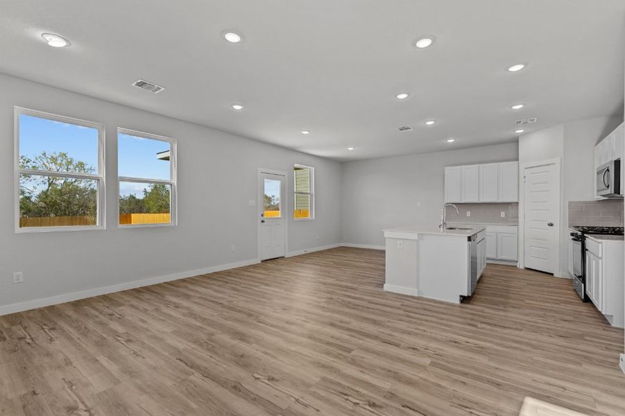 A kitchen with white cabinets.