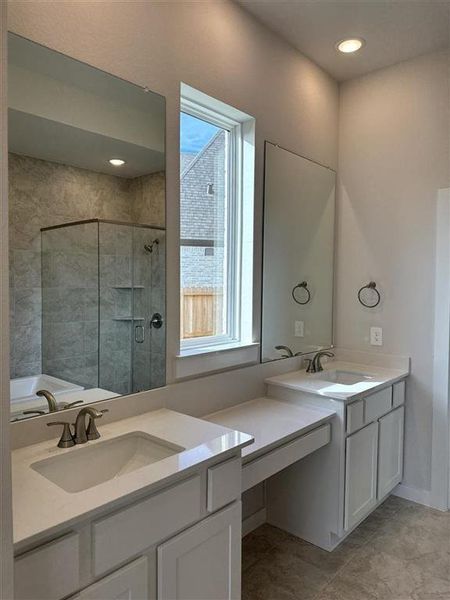 Primary bathroom with his and her sinks and a vanity area!