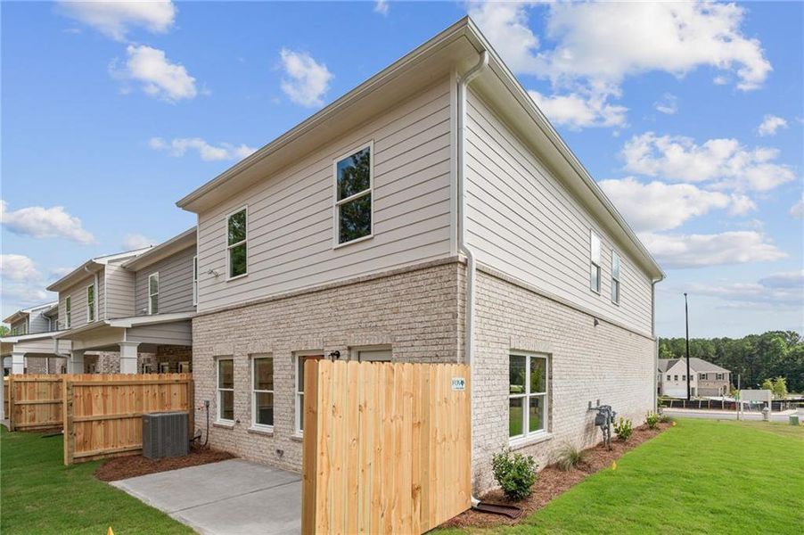 Front exterior of a new home in Wildwood Place, Powder Springs, GA, highlighting curb appeal (Image 18). Front exterior of a new home in Wildwood Place, Powder Springs, GA, highlighting curb appeal (Image 18).