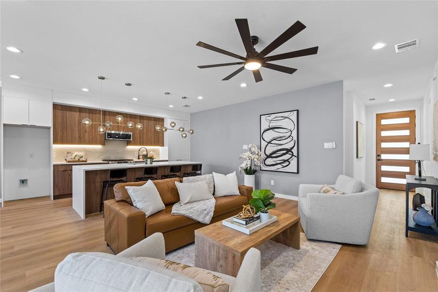 Living area with recessed lighting, light wood finished floors, and ceiling fan Living area with recessed lighting, light wood finished floors, and ceiling fan