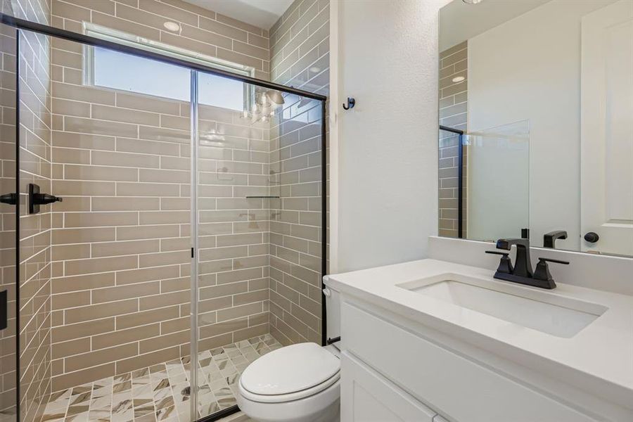 Bathroom with vanity and a shower stall Bathroom with vanity and a shower stall