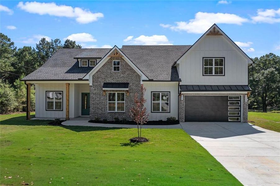 Front exterior of a new home in , Powder Springs, GA, highlighting curb appeal (Image 1). Front exterior of a new home in , Powder Springs, GA, highlighting curb appeal (Image 1).