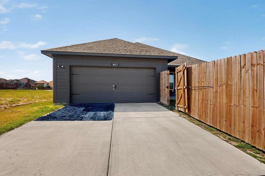 Garage featuring driveway Garage featuring driveway