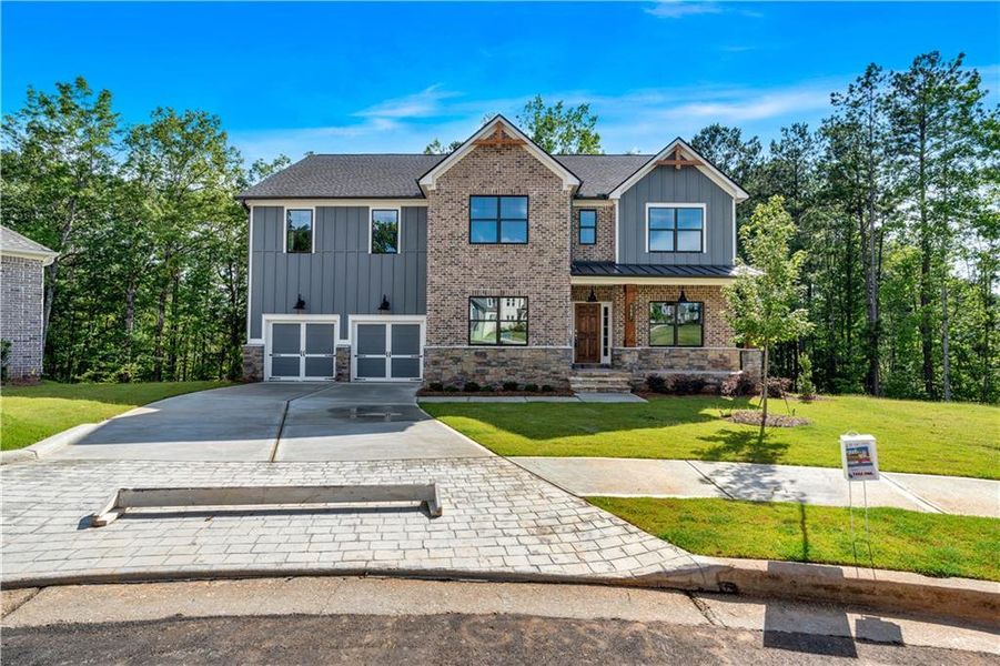 Front exterior of a new home in Palmer Falls, Douglasville, GA, highlighting curb appeal (Image 2).