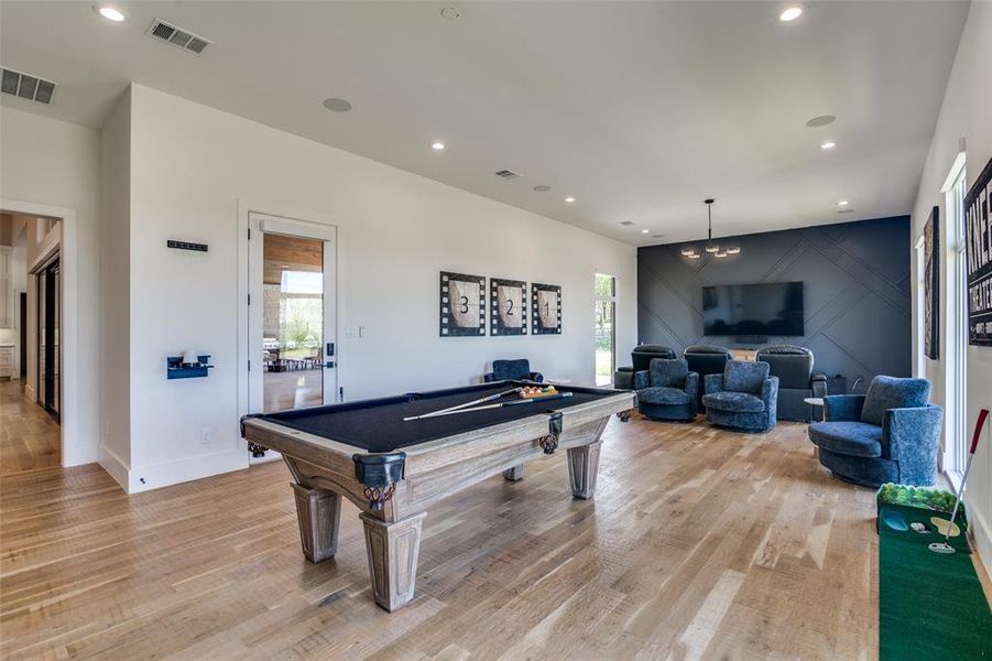 Playroom featuring light hardwood / wood-style floors and pool table