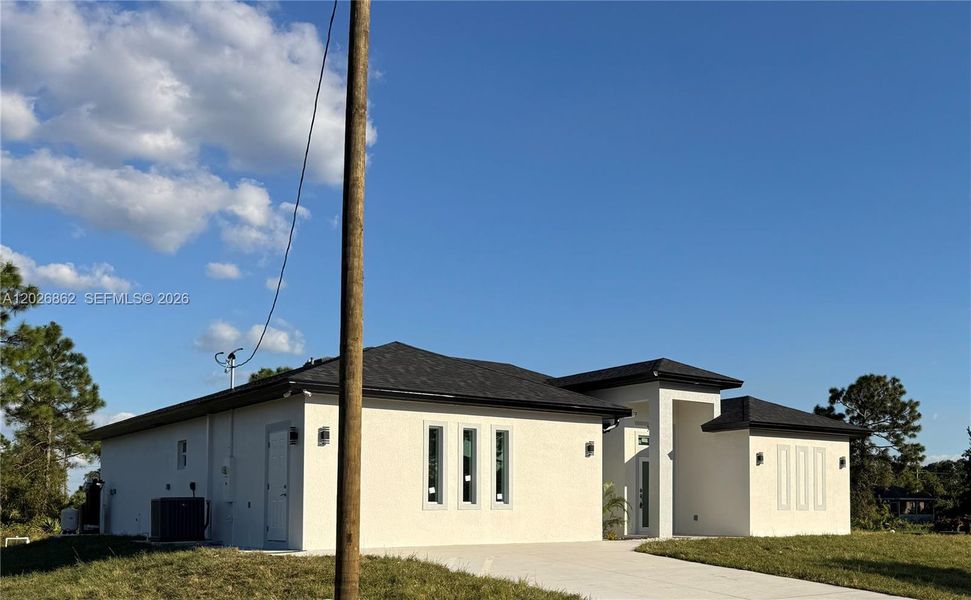 Front exterior of a new home in , Lehigh Acres, FL, highlighting curb appeal (Image 14).
