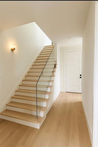 Stairway featuring wood finished floors and baseboards Stairway featuring wood finished floors and baseboards