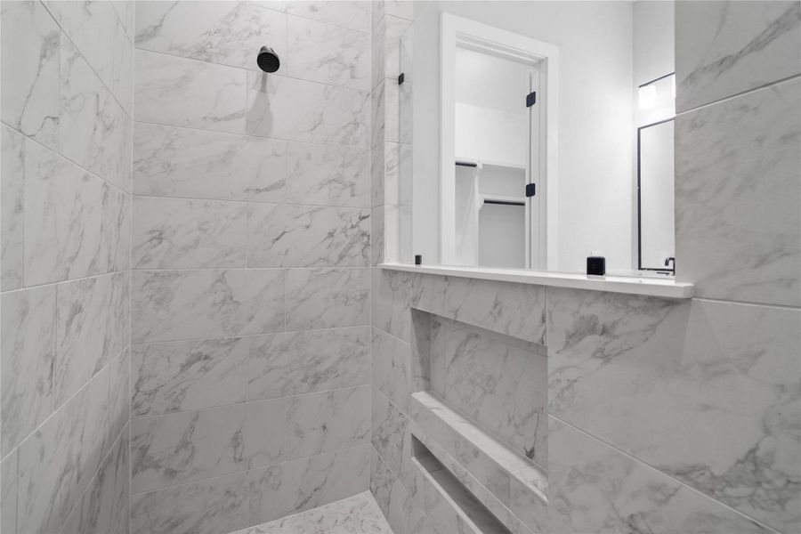 Thoughtfully designed with ultimate convenience in mind, the primary shower features an expansive, integrated double-niche for seamless product storage. Thoughtfully designed with ultimate convenience in mind, the primary shower features an expansive, integrated double-niche for seamless product storage.