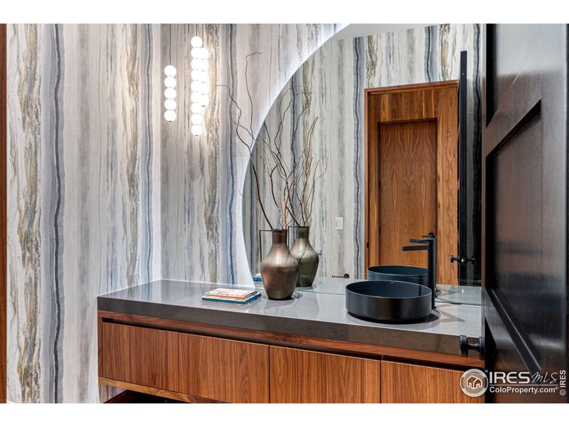 Main floor powder bath with a Neorest Dual Flush Smart bidet toilet, Alape Sink Basin, Franz Viegener Faucet, Pental Quartz slab counter, Anthology Wallpaper and Tech Lighting.