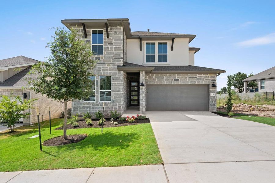 Front exterior of a new home in Wolf Ranch, Georgetown, TX, highlighting curb appeal (Image 1). Front exterior of a new home in Wolf Ranch, Georgetown, TX, highlighting curb appeal (Image 1).