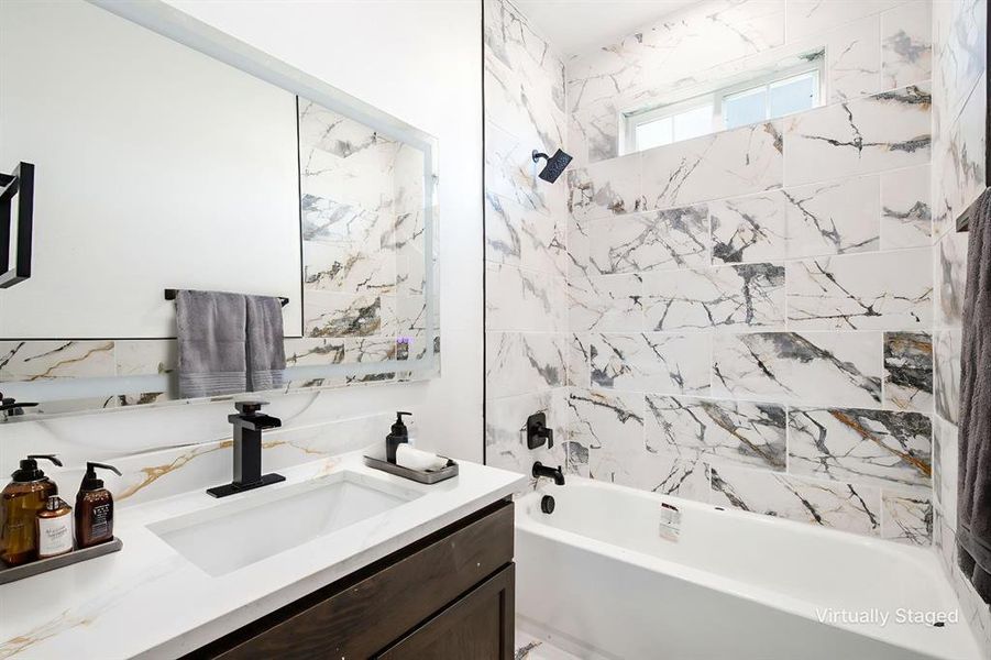 Bathroom featuring bathing tub / shower combination and vanity
