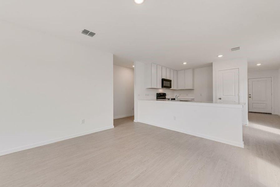 Unfurnished living room featuring light wood-style flooring and recessed lighting