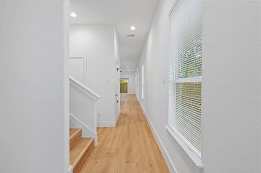 Corridor featuring light wood-type flooring