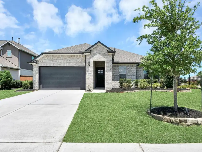 Front exterior of a new home in Lago Mar, Texas City, TX, highlighting curb appeal (Image 2).